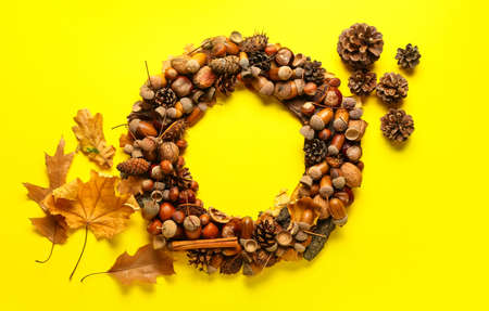 Beautiful acorn wreath on yellow backgroundの写真素材