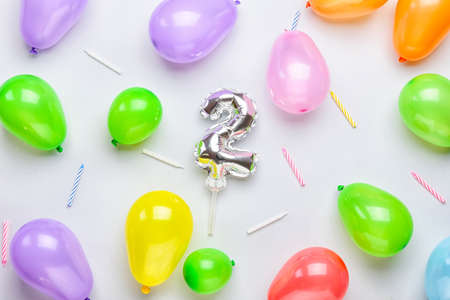 Figure 2, different balloons and candles on light backgroundの写真素材