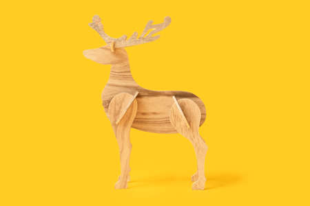 wooden reindeer on yellow backgroundの写真素材