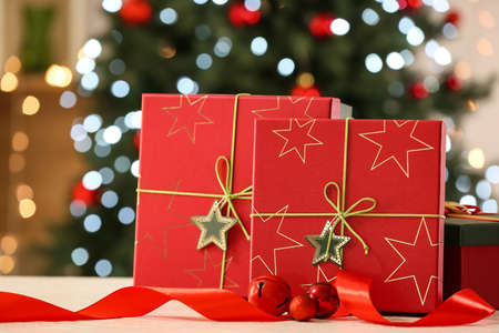 Christmas gift boxes on table against blurred background