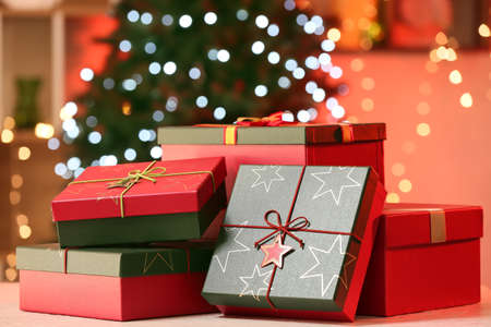 Christmas gift boxes on table against blurred background