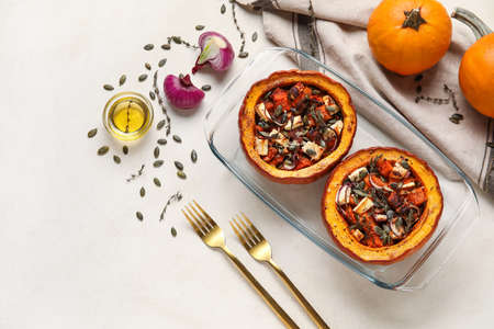 Baking dish with tasty stuffed pumpkins on light backgroundの写真素材