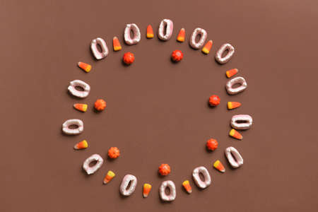 Frame made of Halloween treats on brown backgroundの写真素材