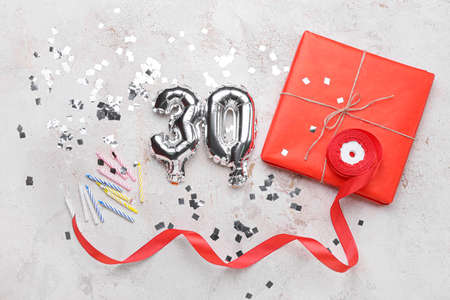 Birthday composition with silver balloons in shape of figure 30 on light backgroundの写真素材