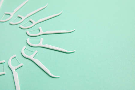 Floss toothpicks on turquoise background, closeupの写真素材