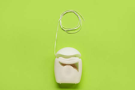 Dental floss on green background