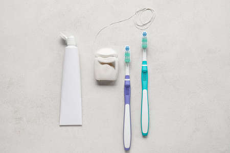 Dental floss with toothbrushes and paste on white backgroundの写真素材