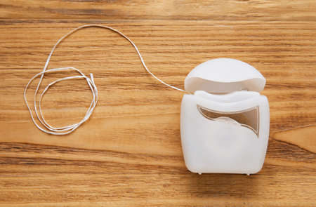 Dental floss on wooden backgroundの写真素材