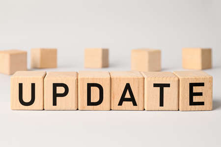 Wooden cubes with word UPDATE on light backgroundの写真素材
