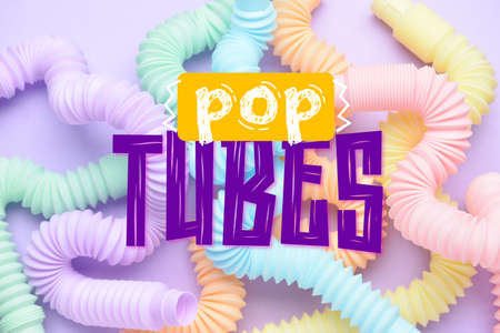 Different colorful Pop Tubes on lilac backgroundの写真素材