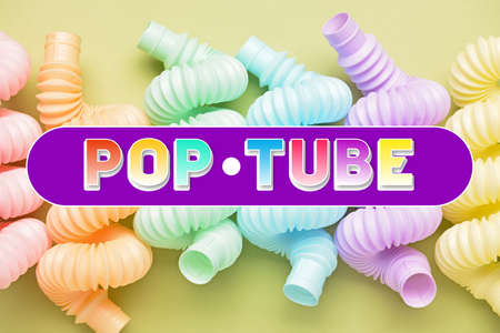 Different colorful Pop Tubes on yellow backgroundの写真素材