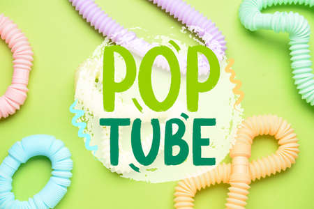Different colorful Pop Tubes on green backgroundの写真素材