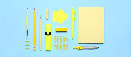 Many school supplies on light blue background, top view