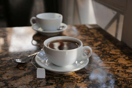 Cups of hot tea on table in cafeの写真素材