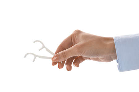 Woman with floss toothpicks on white backgroundの写真素材