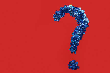 Question mark made of blue sequins on red background