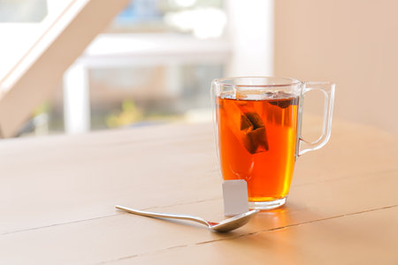Glass cup of hot tea on table in cafeの写真素材