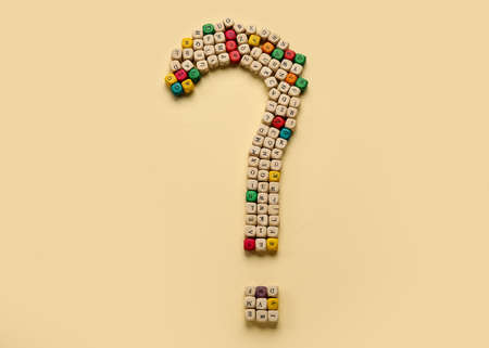 Question mark made of wooden cubes with letters on beige backgroundの写真素材