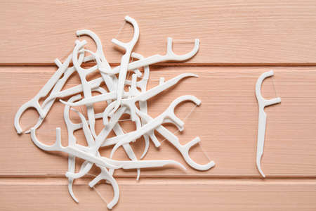 Many floss toothpicks on pink wooden backgroundの写真素材