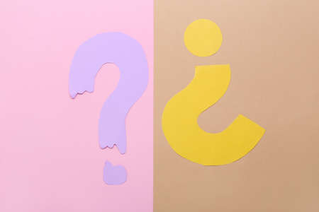 Question marks made of paper on color backgroundの写真素材