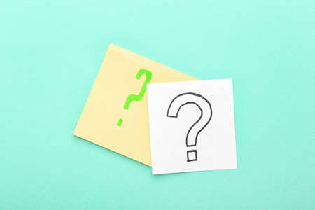 Sticky notes with question marks on blue backgroundの写真素材