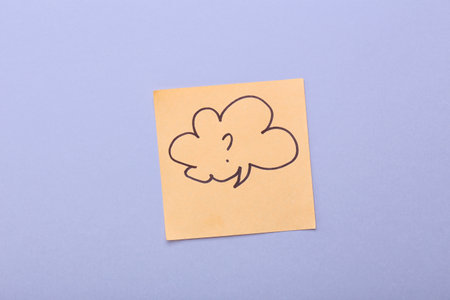 Sticky note with drawn speech bubble and question mark on gray backgroundの写真素材