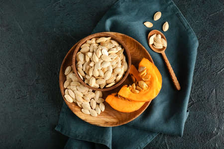 Bowl with natural pumpkin seeds on black backgroundの写真素材
