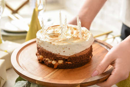 Woman with tasty birthday cake on table, closeupの写真素材