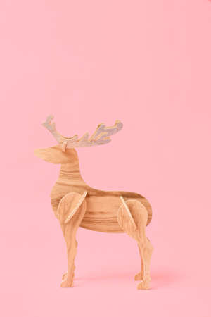 Wooden reindeer on pink backgroundの写真素材