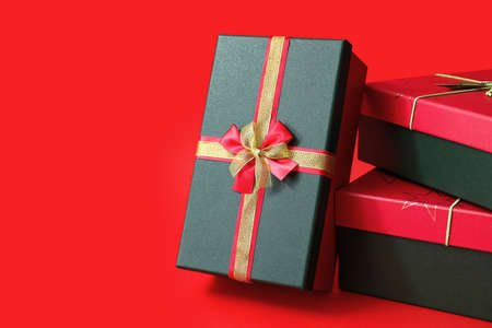 Stack of Christmas gift boxes on red background
