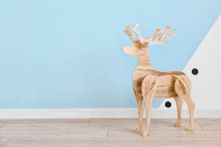 wooden reindeer near blue wallの写真素材