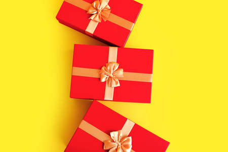 Red Christmas gift boxes on color backgroundの写真素材