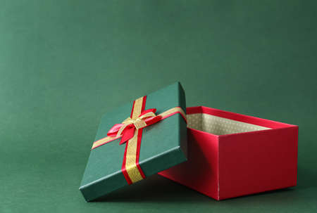 Opened Christmas gift box on color backgroundの写真素材
