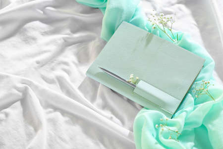 Stylish notebook with gypsophila flowers on light fabric backgroundの写真素材