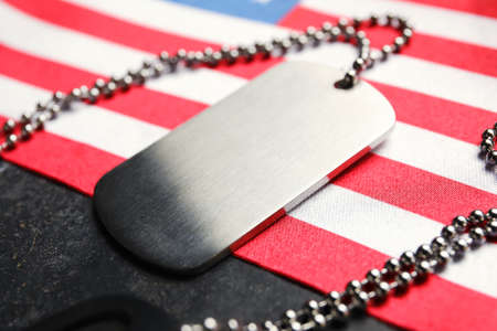 Military tag and flag of USA on dark background, closeupの写真素材