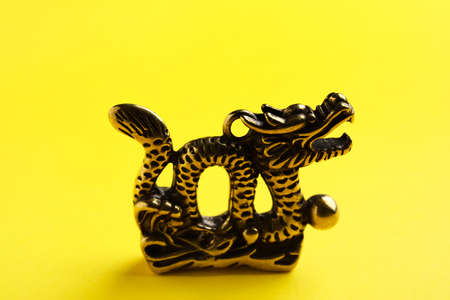 Figurine of Chinese dragon on color backgroundの写真素材