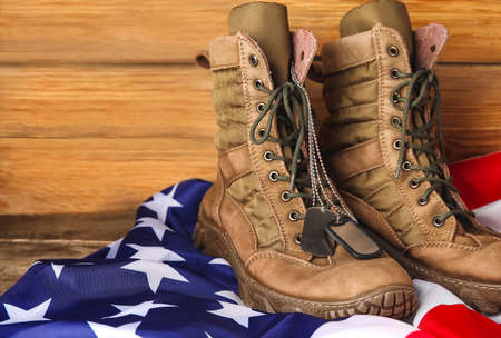 Military boots, tags and USA flag on wooden backgroundの写真素材