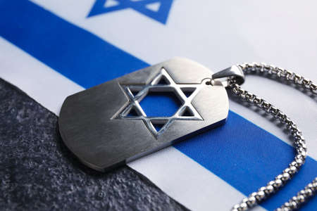 Military tag and flag of Israel on dark background, closeup