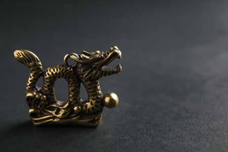 Figurine of Chinese dragon on dark backgroundの写真素材