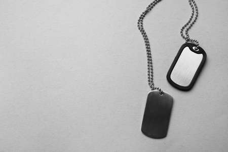 Military dog tags on gray backgroundの写真素材