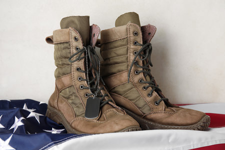 Military boots, tag and USA flag on light backgroundの写真素材