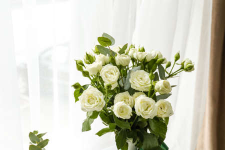 Vase with bouquet of beautiful roses in room, closeupの写真素材