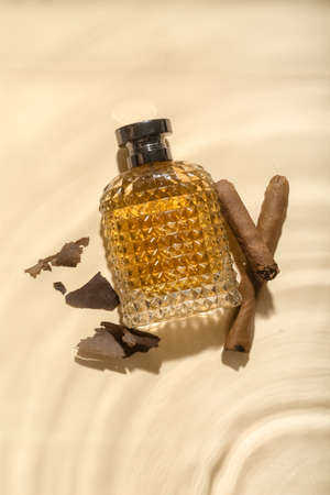 Bottle of perfume for men in water on color backgroundの写真素材