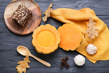 Tasty soup served in pumpkin on black wooden backgroundの写真素材