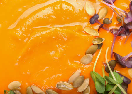 Texture of tasty pumpkin cream soup, closeup