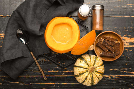 Tasty soup served in pumpkin on black wooden backgroundの写真素材