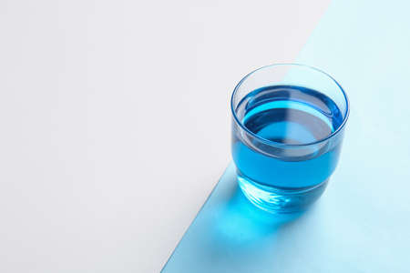 Cup of blue tea on color backgroundの写真素材