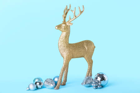 Golden reindeer with Christmas balls on blue backgroundの写真素材