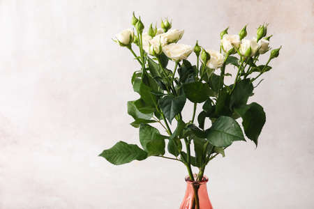 Vase with bouquet of beautiful fresh roses on white background, closeupの写真素材