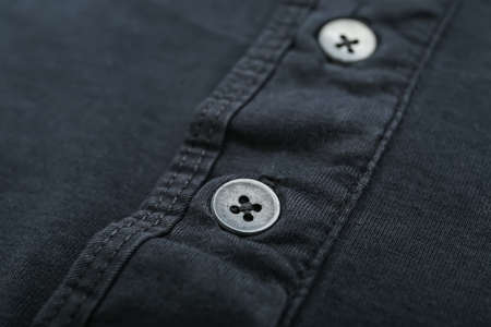 Closeup view of buttons on black cloth